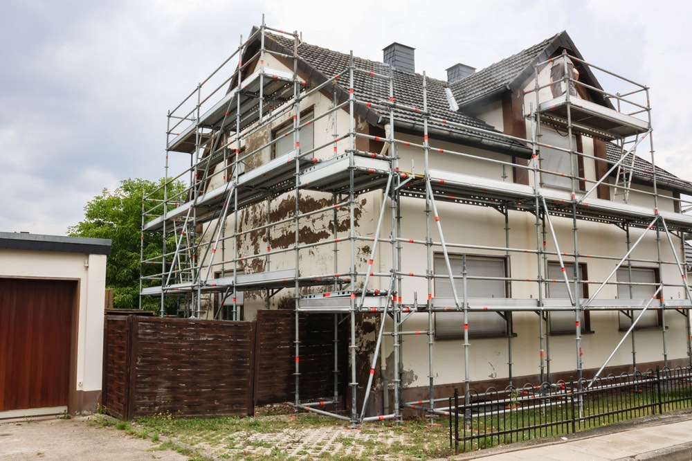 Full scaffolding erected around a two-storey house for external works