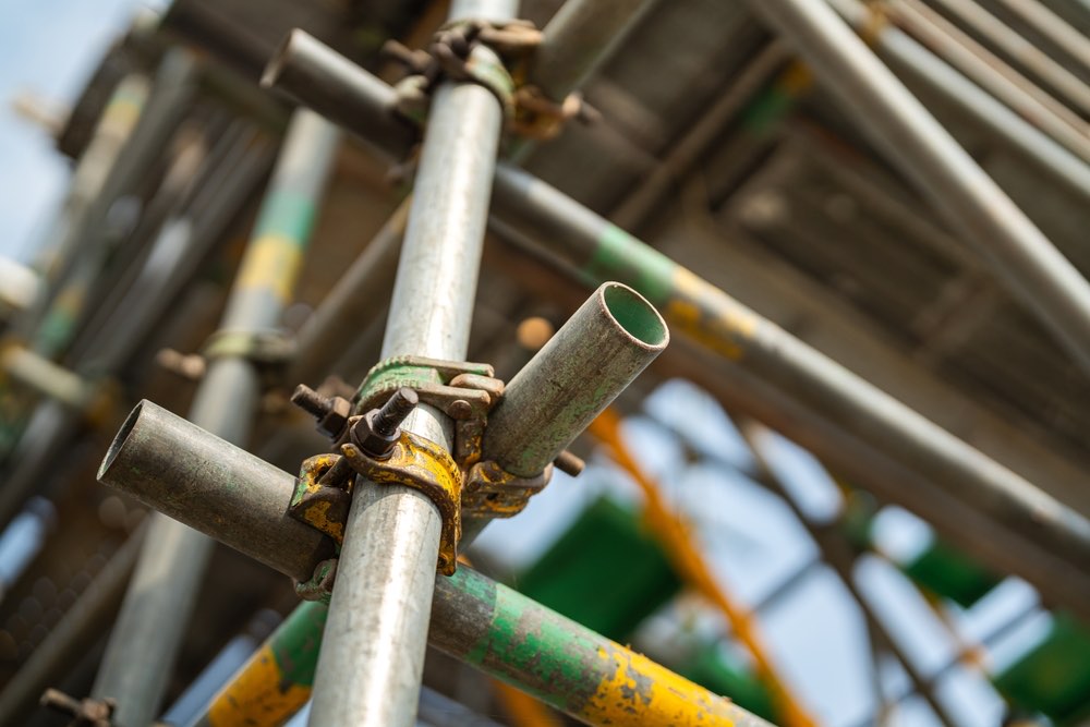 Close-up of scaffold tubes and couplers fixed together