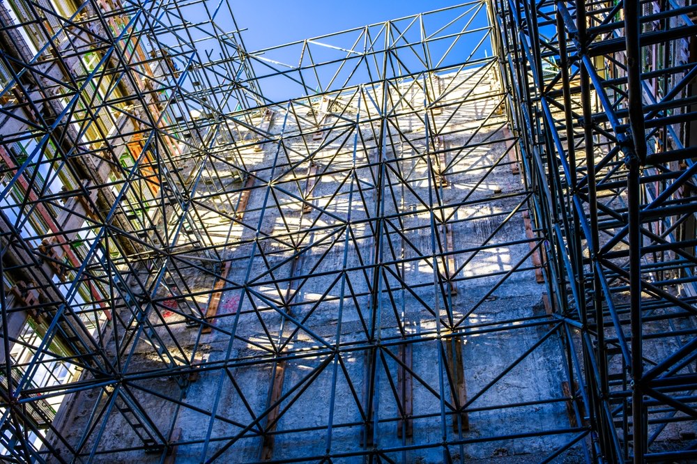 Dense scaffolding framework rising up the face of a large building